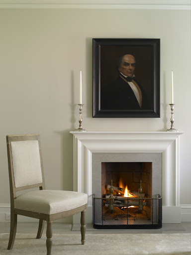 On the mantle, candlesticks draw your focus in, highlighting a prized work of art.