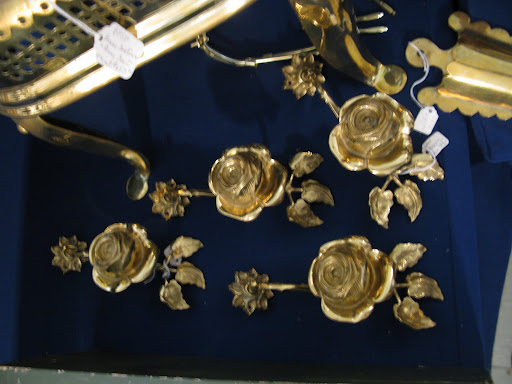 These are actually curtain tie backs in the form of roses. They must have been newly polished, as they sparkled like 14 carat gold. They were laid out on a piece of navy blue velvet which made the presentation especially dramatic. These are actually curtain tie backs in the form of roses. They must have been newly polished, as they sparkled like 14 carat gold. They were laid out on a piece of navy blue velvet which made the presentation especially dramatic.