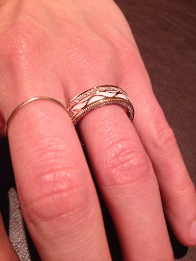 A beautiful ring from Wellendorf in yellow gold, hand-carved white enamel, and diamonds. The center enamel band and diamond band both spin. A beautiful ring from Wellendorf in yellow gold, hand-carved white enamel, and diamonds. The center enamel band and diamond band both spin.