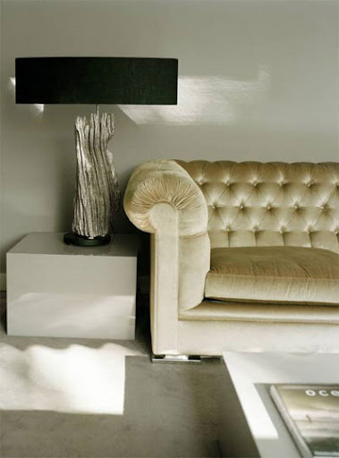 From Citified.blogspot, I love the shimmer the couch provides this living space.