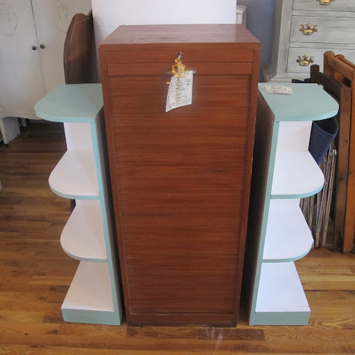 From the front (those side shelving units are not attached) when the rolling door is closed. Once unlocked, the front slatted wood rolls downwards in a truly wonderful whoosh, clinking to a stop at the bottom, revealing the drawers within.