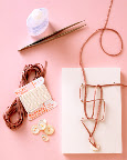 You will need about 45 inches of ribbon or cord for a 7-inch bracelet. A 4-mm width is easiest to work with. You'll also need liquid seam sealant, tweezers, buttons, a foam board, and dressmaker pins, as shown here.