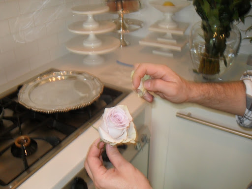 Tom picks off of a few petals to freshen up the look of the Silverstone rose.
