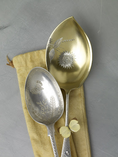These late-Victorian spoons are embellished with intricate butterflies and flowers; the larger one is washed with a thin layer of gold. These late-Victorian spoons are embellished with intricate butterflies and flowers; the larger one is washed with a thin layer of gold.