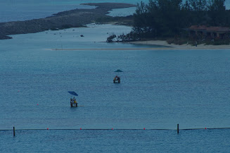 Lifeguards in the water early, waiting for everyone to get off the ship and start getting to the beach.