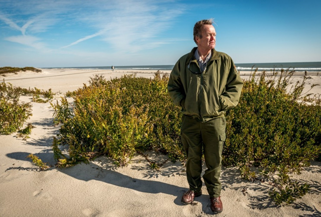 National Park Service Chief of Maintenance for Assateague Island National Seashore, Ish Ennis, stands along the natural dunes on Assateague Island, Maryland, on 18 November 2014. Photo: J.M. Eddins Jr. / The Washington Post