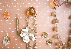 To make the jewelry display case, Anthropologie drawer pulls were screwed into the bottom of an old dresser drawer lined with pretty paper. It can also be used to hold hanging elements, like tag escort cards, at your wedding.