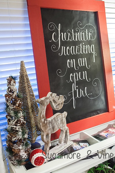 Chestnuts roasting on an open fire print on dining buffet. A truly stunning Christmas Home Tour as part of the Christmas in the Country Blog Tour. This Plaid Inspired Country Christmas will knock your socks off. Features tours of the Living room, Dining Room and a Cocoa hot chocolate bar in the Breakfast room. There is so much inspiration for Christmas decorations in this one post. Be prepared to feel like you are cuddled up by the fire in a warm Northwoods comfy cottage! #country #Christmas #Plaid #Holiday decorating #Holiday ideas #Holidays #Christmas decor #Holiday decor Chestnuts roasting on an open fire print on dining buffet. A truly stunning Christmas Home Tour as part of the Christmas in the Country Blog Tour. This Plaid Inspired Country Christmas will knock your socks off. Features tours of the Living room, Dining Room and a Cocoa hot chocolate bar in the Breakfast room. There is so much inspiration for Christmas decorations in this one post. Be prepared to feel like you are cuddled up by the fire in a warm Northwoods comfy cottage! #country #Christmas #Plaid #Holiday decorating #Holiday ideas #Holidays #Christmas decor #Holiday decor
