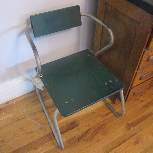 The sinuous lines of this deep green metal chair are provocative.