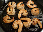 Marinated shrimp cooking on the grill pan-take them off as soon as they're opaque throughout.