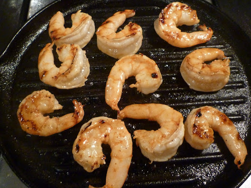 Marinated shrimp cooking on the grill pan-take them off as soon as they're opaque throughout.