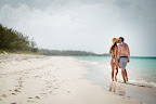 The love birds took a stroll on the beach.