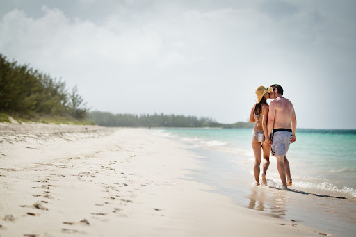 The love birds took a stroll on the beach.