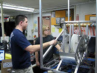 A mentor explains the frame design to a student