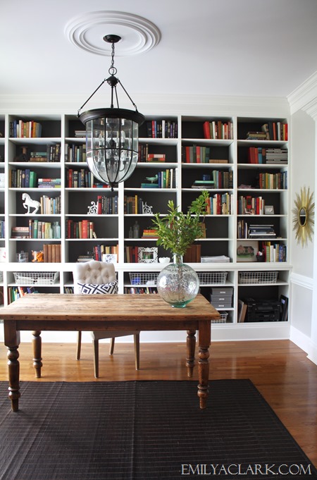 home office & library with farmhouse table, bookshelves, and lantern