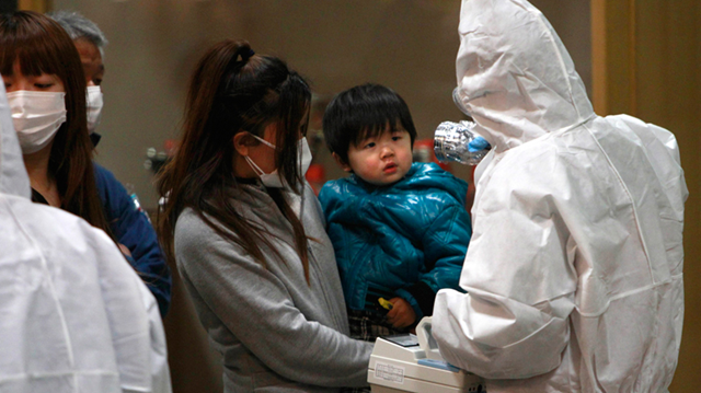 A child is screened for radiation exposure at a testing centre in Koriyama city, Fukushima Prefecture, Japan, Tuesday, March 15, 2011 after a nuclear power plant on the coast of the prefecture was damaged by Friday's earthquake. AP / Wally Santana