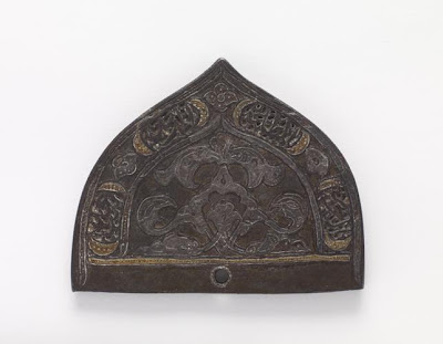 A comb back | Origin:  Iran | Period: 17th century  Safavid period | Details:  Not Available | Type: Iron | Size: H: 6.2  W: 7.7  cm | Museum Code: F1940.4 | Photograph and description taken from Freer and the Sackler (Smithsonian) Museums.
