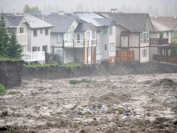 Debris and water pour across the Trans-Canada Highway as Canmore struggles to deal with massive flooding on 20 June 2013. Photo: Craig Douce / Rocky Mountain Outlook