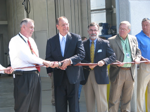 Instead of a ribbon cutting, airport officials unscrewed a fire hose to open the new facility.