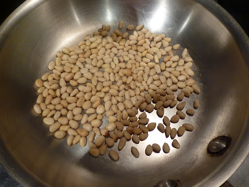 Toast pine nuts in a skillet until lightly golden.