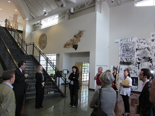 Art by students, graduates, faculty, and visiting artists covers the sunlit hallways.