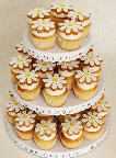 Here I put Eleni’s sweet daisy cookies (included in the sale) on top of vanilla cupcakes from Butterfly Bakeshop. You can stack your cookie-topped cupcakes on this Martha Stewart Crafts cupcake stand (included in this sale) or put out plates of the treats for your guests to nibble on.