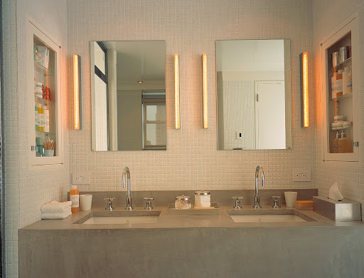 The placement of the mirrors, medicine cabinets, and lighting above these double sinks gives this modern bathroom a sense of calm. The placement of the mirrors, medicine cabinets, and lighting above these double sinks gives this modern bathroom a sense of calm.