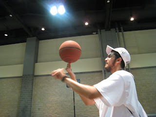 A brother rolling a basketball on his finger