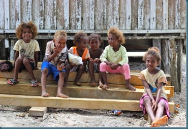 kids sitting on boards