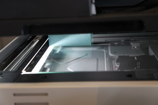 Lower the lid down and don't look at the bright, bright light as it scans the painting!