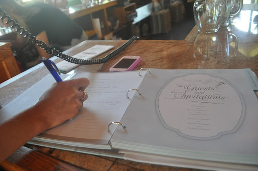 Irina took notes while chatting about venue details with one of the event planning staff. The main takeaway: They'd have to make room in the budget for rentals because not much is provided other than the space at Duckwalk.