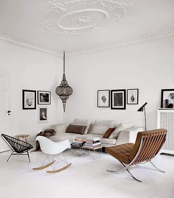 white-rug-white-rocking-chair-black-cool-chair-brown-comfy-chair-small-table-books-bar-stool-grey-sofa-with-cushions-pendant-lamp-paintings-on-the-wall-floor-lamp