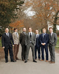 Groom Neal and his groomsmen strike a casual pose before the ceremony in shades of brown, gray, black, and navy. Groom Neal and his groomsmen strike a casual pose before the ceremony in shades of brown, gray, black, and navy.