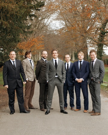 Groom Neal and his groomsmen strike a casual pose before the ceremony in shades of brown, gray, black, and navy. Groom Neal and his groomsmen strike a casual pose before the ceremony in shades of brown, gray, black, and navy.