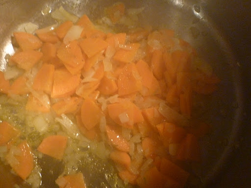 Onions, carrots, and rosemary softening in the pressure cooker..