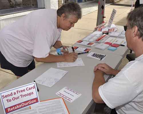 another guest signing a free greeting card for our overseas troops