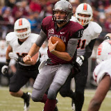 Shay Smithwick-Hann, one of three Montana quarterbacks to play Saturday, takes a quarterback keeper up the middle.  Starter at the position, Smithwick-Hann logged 250 yards and 3 touchdowns on the day.

Washington-Grizzly Stadium in Missoula, Mont., October 27th, 2012.
