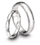 Memoire's Toujours Collection platinum wedding bands feature milligrain edging in the men's band and diamond accents in the women's style. We love that they work together without being too matchy-matchy!