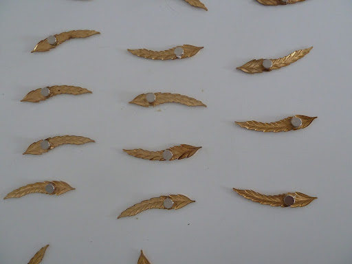 Adding the magnets to the backs of the feathers we used to display our escort cards.