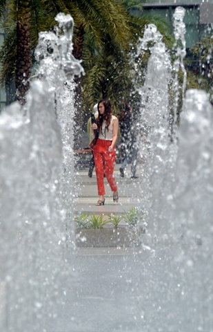 A pedestrian walks past a water fountain on a hot day in Bangkok on 3 May 2012. Thailand's weather consists of 3 seasons, the 'cool' from November to February, 'hot' from March to June and the 'wet' from July to October. PORNCHAI KITTIWONGSAKUL / Getty Images