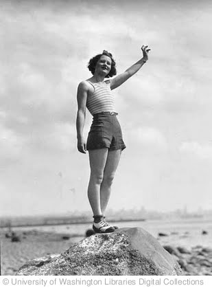 'Woman in a swimsuit waving while standing on a large rock on a beach, probably Washington State' photo (c) 1932, University of Washington Libraries Digital Collections - license: http://www.flickr.com/commons/usage/