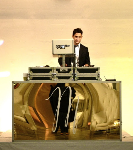The DJ booth was customized with a gold panel and a calligraphed The DJ booth was customized with a gold panel and a calligraphed