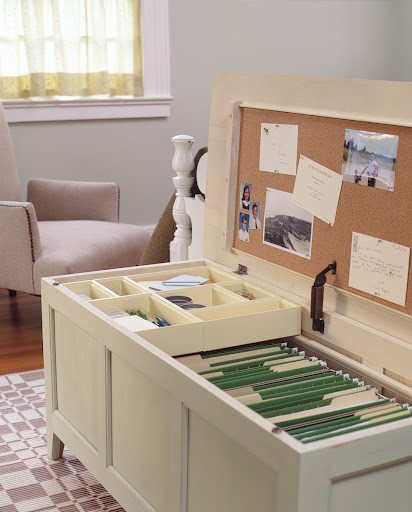Here the tray fits inside of a storage bench for a pop-up office. We used molding as rails for the tray, cork sheeting for a pin board, and adjustable rods to hang files from.
