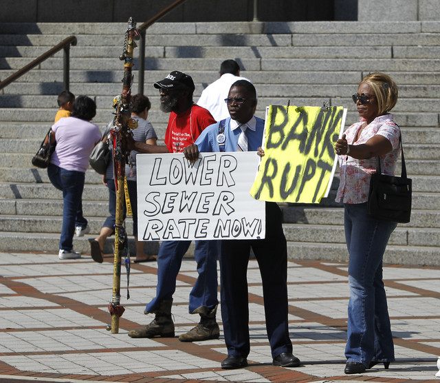 Joe Minter, Harry Turner, and Mabel Nunn demonstrate outside the Jefferson County courthouse as the county commissioners meet about the Jefferson County bankruptcy on 12 August 2011 in Brimingham. Butch Dill / AP