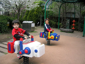 Kai and Kento riding the robots at Robot Park