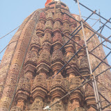 On the top, below amalaka, are seen some human faces.