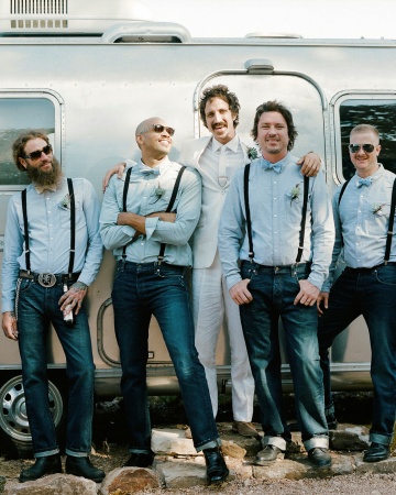 For a wedding in Round Mountain, Texas, groomsmen wore vintage-wash Levi's 501 jeans, pale blue button-down shirts, and suspenders. Reversible bow ties (chambray on one side, ivory with red polka dots on the other) were made by the mother of the groom. For a wedding in Round Mountain, Texas, groomsmen wore vintage-wash Levi's 501 jeans, pale blue button-down shirts, and suspenders. Reversible bow ties (chambray on one side, ivory with red polka dots on the other) were made by the mother of the groom.