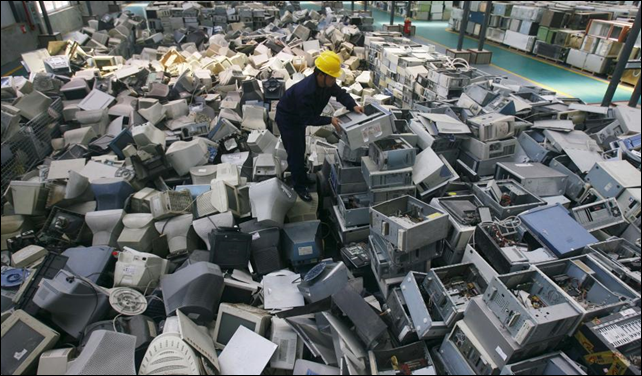 An employee arranges discarded computers at a newly opened electronic waste recycling factory in Wuhan, Hubei province, China. Photo: REUTERS