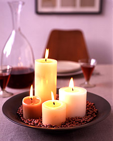Arrange pillar candles of different sizes and colors in a serving platter or shallow bowl. Then, surround the candles with a layer of dried beans (we used kidney beans, but pink lentils, red beans, and red rice also work nicely). Beans make cleanup of the wax easy and unify a group of candles into a true centerpiece. Arrange pillar candles of different sizes and colors in a serving platter or shallow bowl. Then, surround the candles with a layer of dried beans (we used kidney beans, but pink lentils, red beans, and red rice also work nicely). Beans make cleanup of the wax easy and unify a group of candles into a true centerpiece.