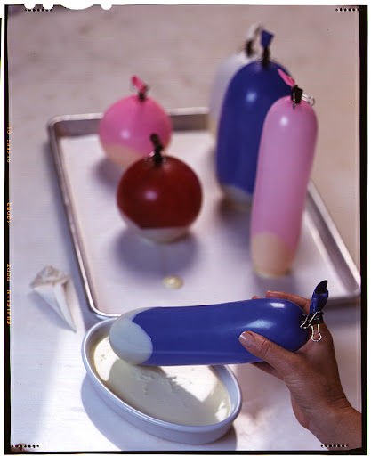 Melt down chocolates to create shells for serving berries or ice cream. Inflate balloons and clip them with a binder clip. Dunk balloons into slightly cooled, melted chocolate. Wait about a minute and then dunk again. Place chocolate dipped balloons on a parchment lined baking sheet and refrigerate until set. Remove balloons from shells. Melt down chocolates to create shells for serving berries or ice cream. Inflate balloons and clip them with a binder clip. Dunk balloons into slightly cooled, melted chocolate. Wait about a minute and then dunk again. Place chocolate dipped balloons on a parchment lined baking sheet and refrigerate until set. Remove balloons from shells.